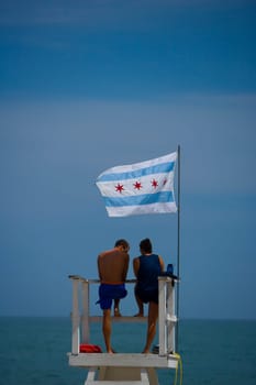 Tourists standing on a lifeguard hut, Oak Street Beach, 1000 North Lake Shore Drive, Chicago, Illinois, USA