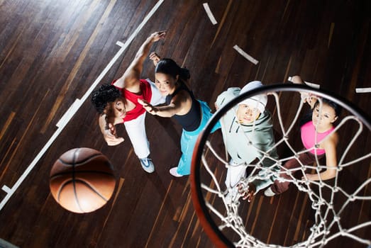 High angle view of two young men with two young women playing basketball