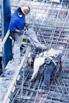 High angle view of two construction workers working at a construction site