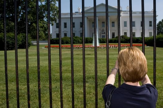 Rear view of a woman looking at a government building, White House, Washington DC, USA