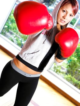 Portrait of a young woman practicing boxing