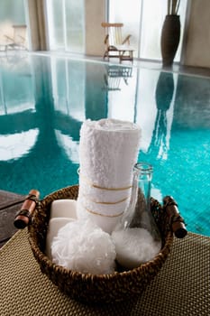 Spa products in a basket at the poolside
