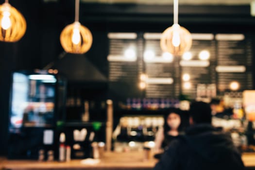 Blurred loft coffee shop with barista and customer. High quality photo