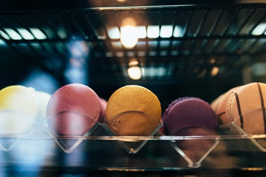 Multicolored macarons on a showcase in a cafe. High quality photo