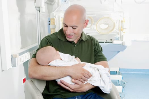 Man carrying his newborn baby
