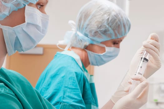 Surgeons performing a surgery in an operating room