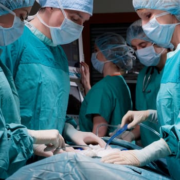 Surgeons performing a surgery in an operating room
