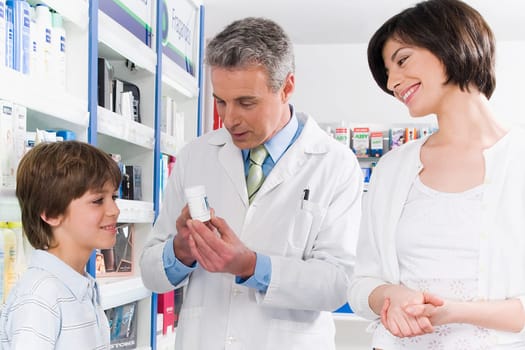 Pharmacist talking with a boy