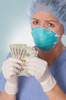 Female surgeon holding currency notes