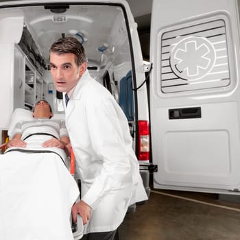 Doctor pushing a patient on a gurney from an ambulance