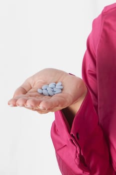 WomanŽs hand holding pills