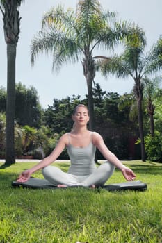 Woman practicing yoga in a park