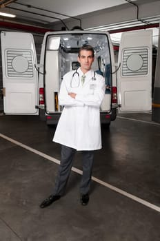 Doctor standing with an ambulance behind him