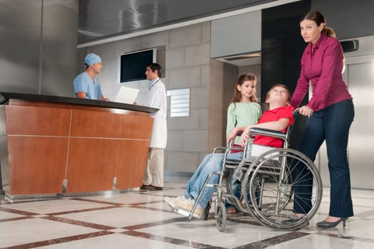 Woman pushing her son in a wheelchair