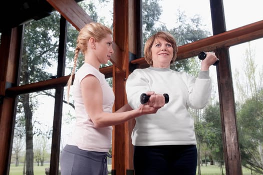 Physiotherapist helping a disabled woman in exercising