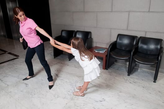 Girl tugging her mother in a hospital
