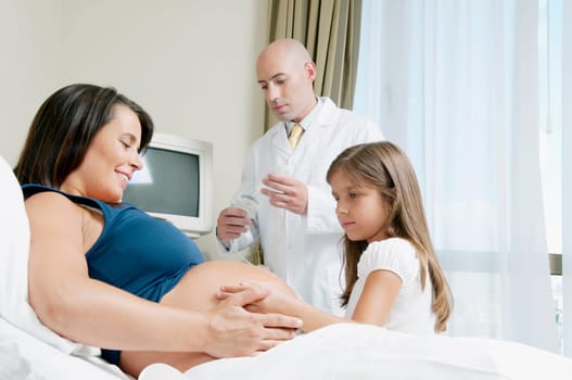 Pregnant woman in a hospital with her daughter