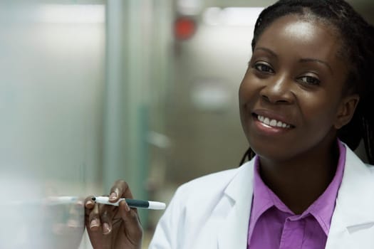 Female doctor writing on a whiteboard in a hospital