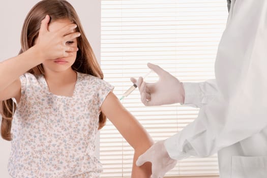 Doctor giving an injecting to a girl