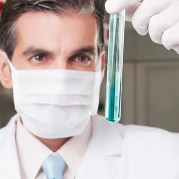 Lab technician analyzing sample in a test tube