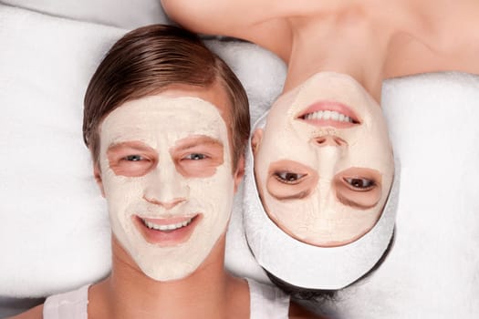 Couple with face pack on their faces