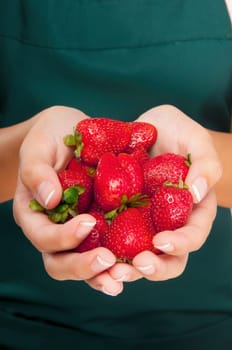 Woman holding handful of strawberries