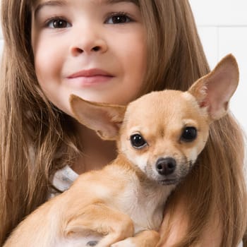 Girl carrying a dog in a veterinary hospital