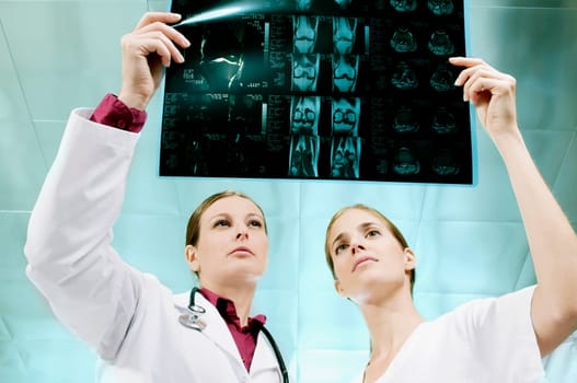 Female doctor and a nurse examining an X_Ray
