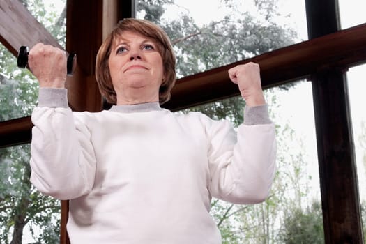 Disabled woman exercising with dumbbells