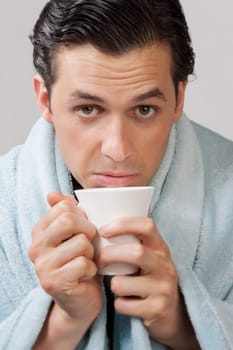 Portrait of a man taking hot drink