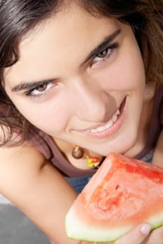 Portrait of a woman holding a slice of watermelon