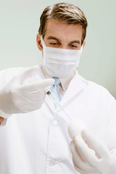 Lab technician injecting into an egg