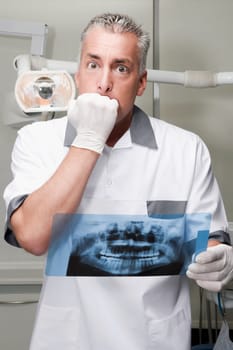 Dentist examining an X_Ray report