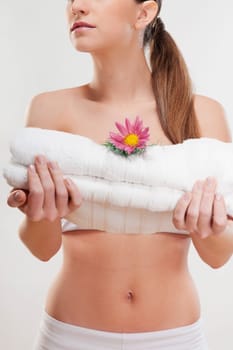 Woman holding towels with a flower