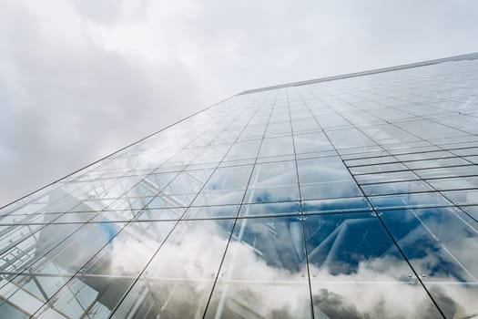 Reflection of the sky on a skyscraper. View of skyscrapers from below
