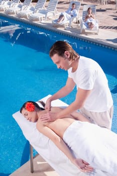 Woman receiving back massage from a massage therapist