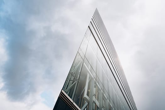 Dramatic view of skyscrapers against cloudy sky. View of the skyscraper from below