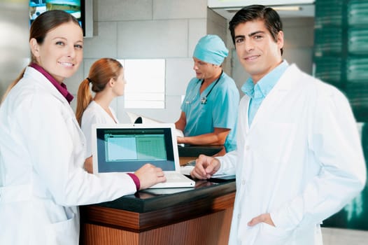 Two doctors discussing a medical report on a laptop