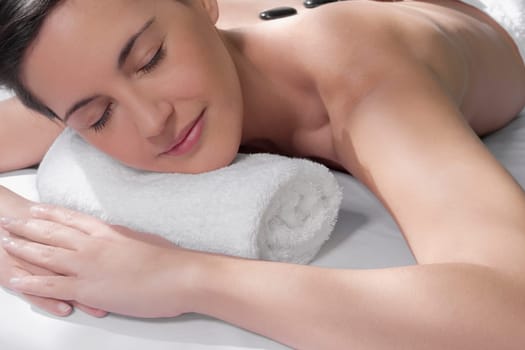 Woman receiving hot stone therapy