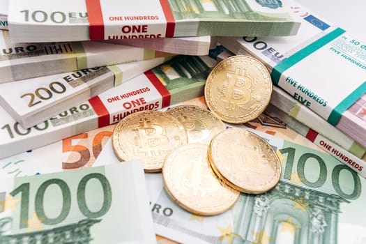 Crypto currency concept - a bitcoin with euro bills. Bitcoin and Euro banknotes. Cryptocurrency lies on the money