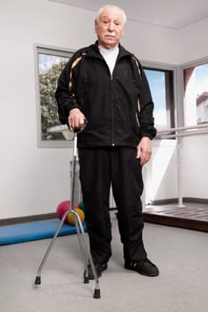 Portrait of a man standing with a crutch