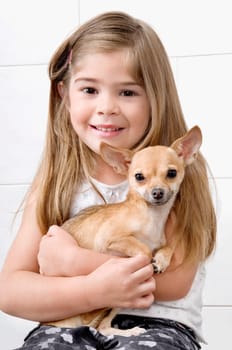 Girl carrying a dog in a veterinary hospital