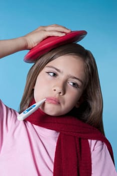 Girl taking her temperature and applying ice pack