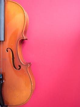 Detail of a violin against a coloured background