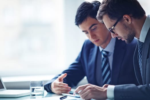 Two confident businessmen networking in office