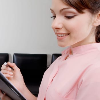 Close_up of a female doctor holding a file