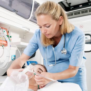 Female nurse adjusting oxygen mask of a patient