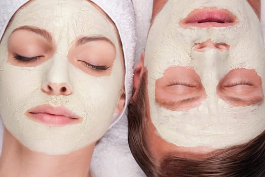 Couple with face pack on their faces