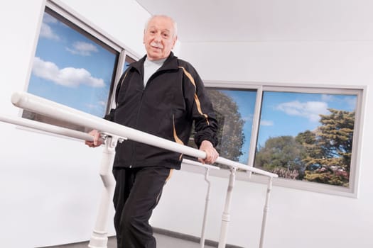 Disabled man practicing on a walker