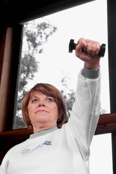 Disabled woman exercising with dumbbells